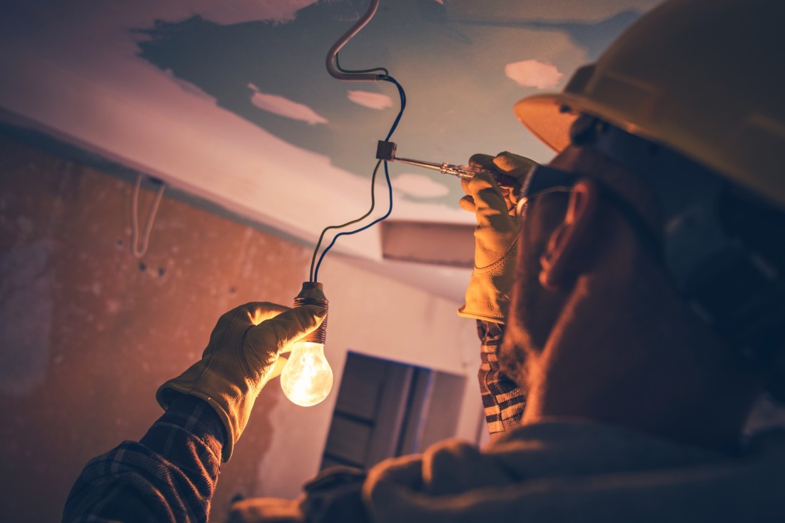 Photo of electrician holding and bulb